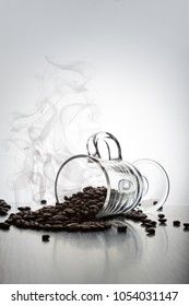 coffee beans are spilled out of an Irish glass mug on a white background