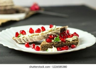 sandwich with cheese, greens and pomegranate berries 