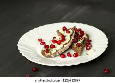 sandwich with cheese, greens and pomegranate berries 
