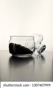 Coffee beans in a glass jar isolated on a back white background