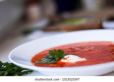 Traditional Ukrainian Russian borsch with sour cream and white beans, macro . Red vegetable beetroot soup.