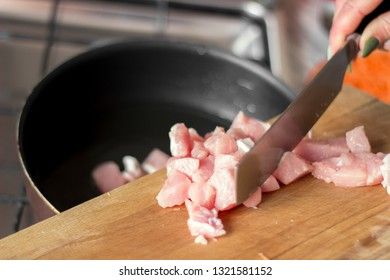 Laying raw pork pieces on a cutting board