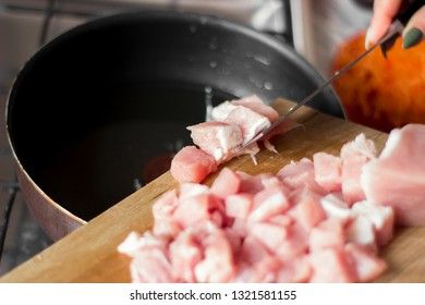 Laying raw pork pieces on a cutting board