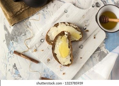 Pieces of bread with butter and honey, view from above