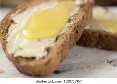 Pieces of bread with butter and honey, macro