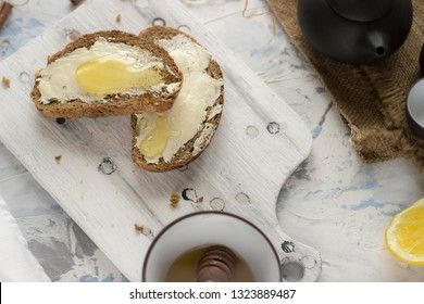 Pieces of bread with butter and honey