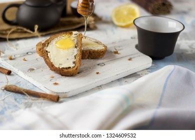 Pieces of bread with butter and honey