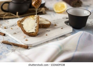 Pieces of bread with butter and honey