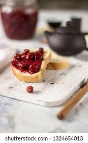 Bread with homemade cherry jam on a light background, closeup