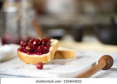 Bread with homemade cherry jam on a light background, closeup