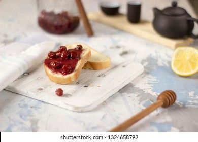 Bread with homemade cherry jam on a light background, closeup