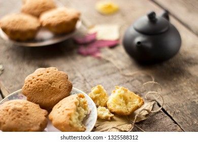 Sweet cupcakes on old wooden background.