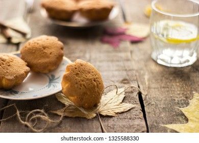 Sweet cupcakes on old wooden background.
