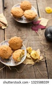 Sweet cupcakes on old wooden background.