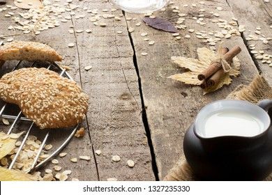 Oatmeal cookies with milk on tray on rustic wooden table