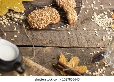 Oatmeal cookies with milk on tray on rustic wooden table