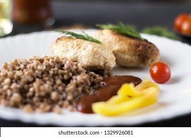 Chicken cutlets with buckwheat, herbs, ketchup and tomatoes