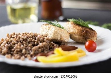 Chicken cutlets with buckwheat, herbs, ketchup and tomatoes