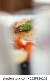 Chicken cutlets with herbs, ketchup and tomatoes