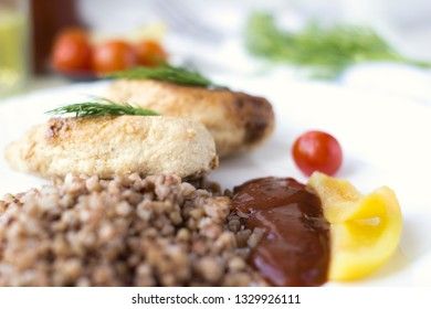 Chicken cutlets with buckwheat, herbs, ketchup and tomatoes