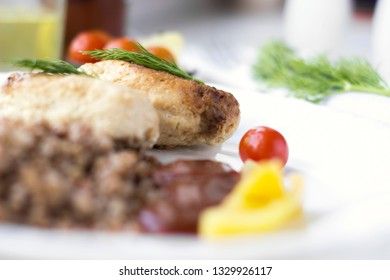 Chicken cutlets with buckwheat, herbs, ketchup and tomatoes
