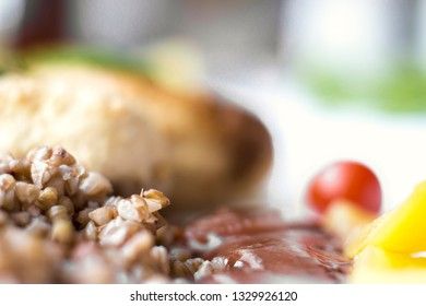 Chicken cutlets with buckwheat, herbs, ketchup and tomatoes