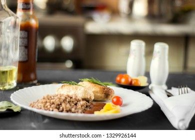 Chicken cutlets with buckwheat, herbs, ketchup and tomatoes