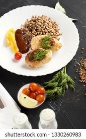 Chicken cutlets with buckwheat, herbs, ketchup and tomatoes