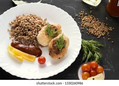 Chicken cutlets with buckwheat, herbs, ketchup and tomatoes