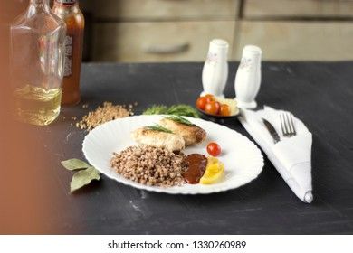 Chicken cutlets with buckwheat, herbs, ketchup and tomatoes