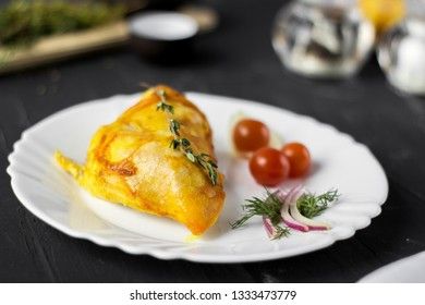 Baked chicken breast with onions and tomatoes on a white plate. Healthy food.