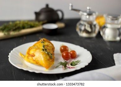 Baked chicken breast with onions and tomatoes on a white plate. Healthy food.