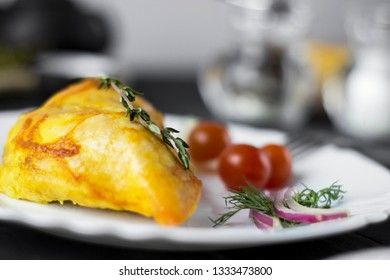 Baked chicken breast with onions and tomatoes on a white plate. Healthy food.