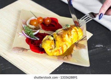 Baked chicken breast with onions and tomatoes on a white plate. Healthy food.