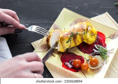 Baked chicken breast with onions and tomatoes on a white plate. Healthy food.