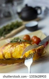 Baked chicken breast with onions and tomatoes on a white plate. Healthy food.
