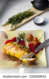 Baked chicken breast with onions and tomatoes on a white plate. Healthy food.