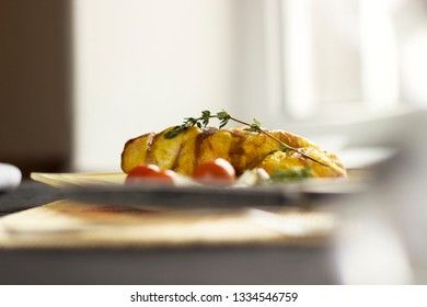 Baked chicken breast with onions and tomatoes on a white plate. Healthy food.