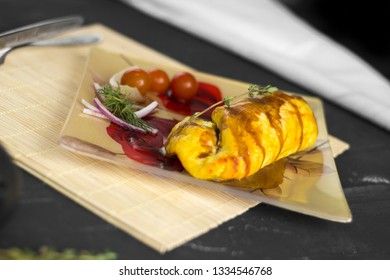 Baked chicken breast with onions and tomatoes on a white plate. Healthy food.