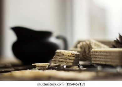 Sweet russian artek waffles on wooden background, with a pot of milk. Traditional sweets and dessert.
