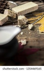 Sweet russian artek waffles on wooden background, with a pot of milk. Traditional sweets and dessert.