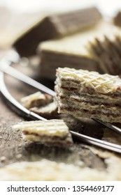 Sweet russian artek waffles on wooden background, with a pot of milk. Traditional sweets and dessert.