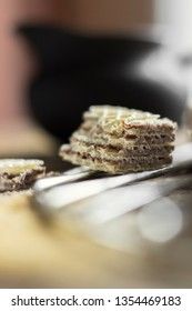 Sweet russian artek waffles on wooden background, with a pot of milk. Traditional sweets and dessert.