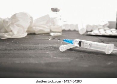 Medical ampoules with vaccine and syringe on gray, white background. Medical ampoules with pure vaccine and syringe on gray background