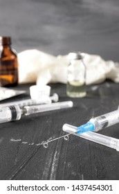 Medical ampoules with vaccine and syringe on gray background. Medical ampoules with pure vaccine and syringe on gray background