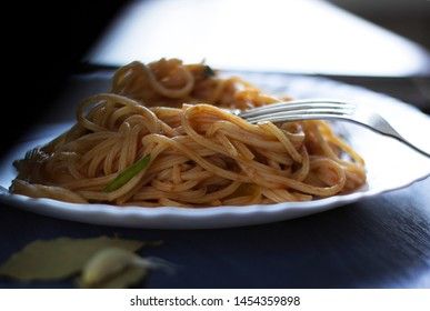Delicious pasta with egg yolk, on wooden table.