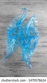 blue shoe covers on a wooden table top view