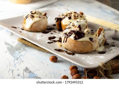 original cinnabon rolls with chocolate-cream sauce and hazelnuts