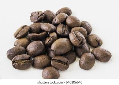 Coffee beans in macro over white background