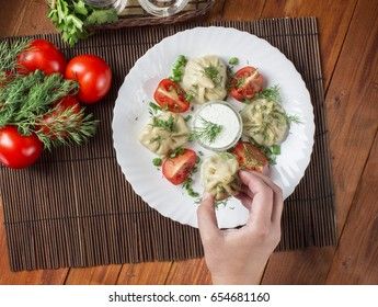 meat, greens and tomatoes on a wooden background